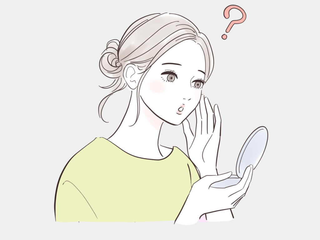 コンパクトを見ながら、不思議そうにするお団子頭の女性